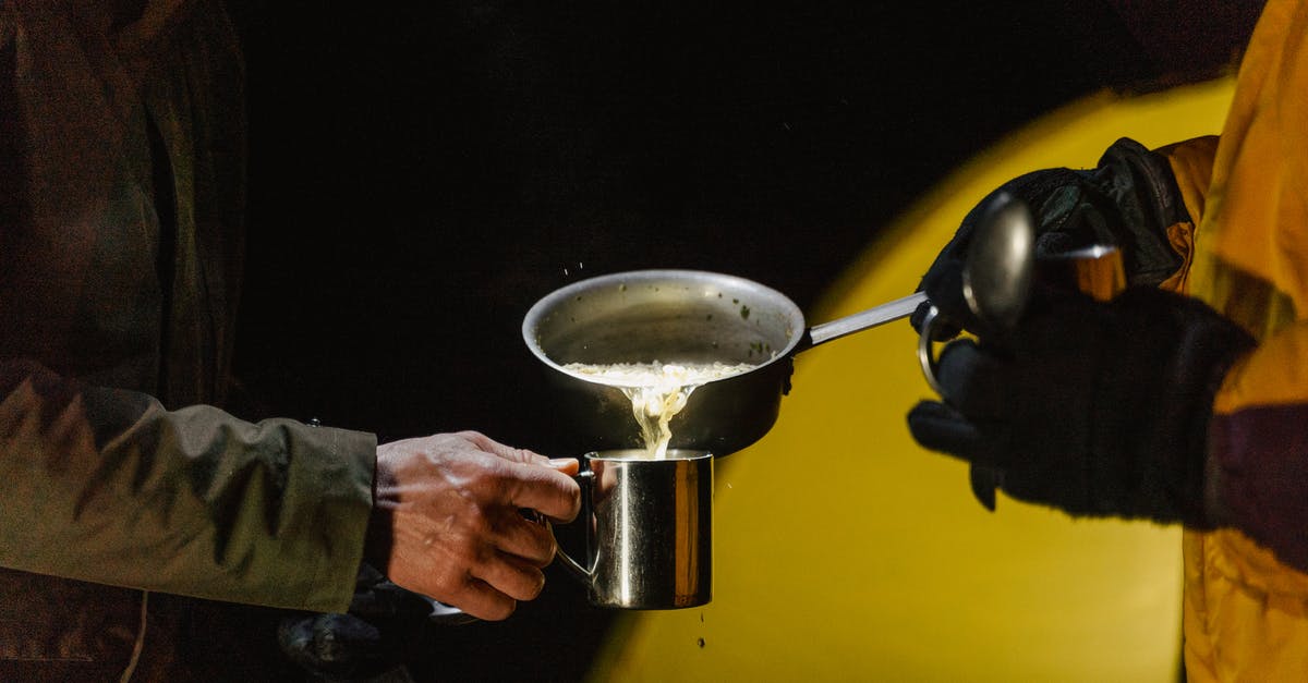 Places for camping without a caravan in UK - A Person Pouring Food in Silver Cup