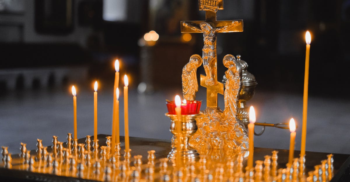 Places in and around Bangalore [closed] - Gold Cross With Candles on Table