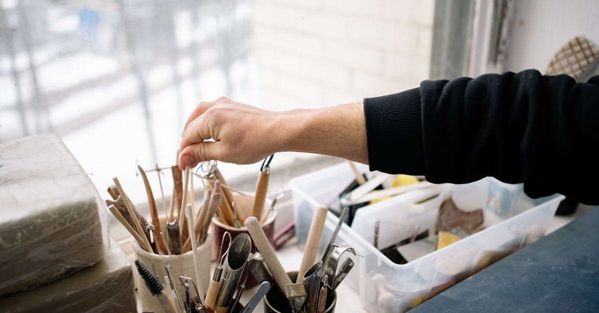 Places in and around Bangalore [closed] - Close-up of a Person Choosing a Tool in an Art Studio