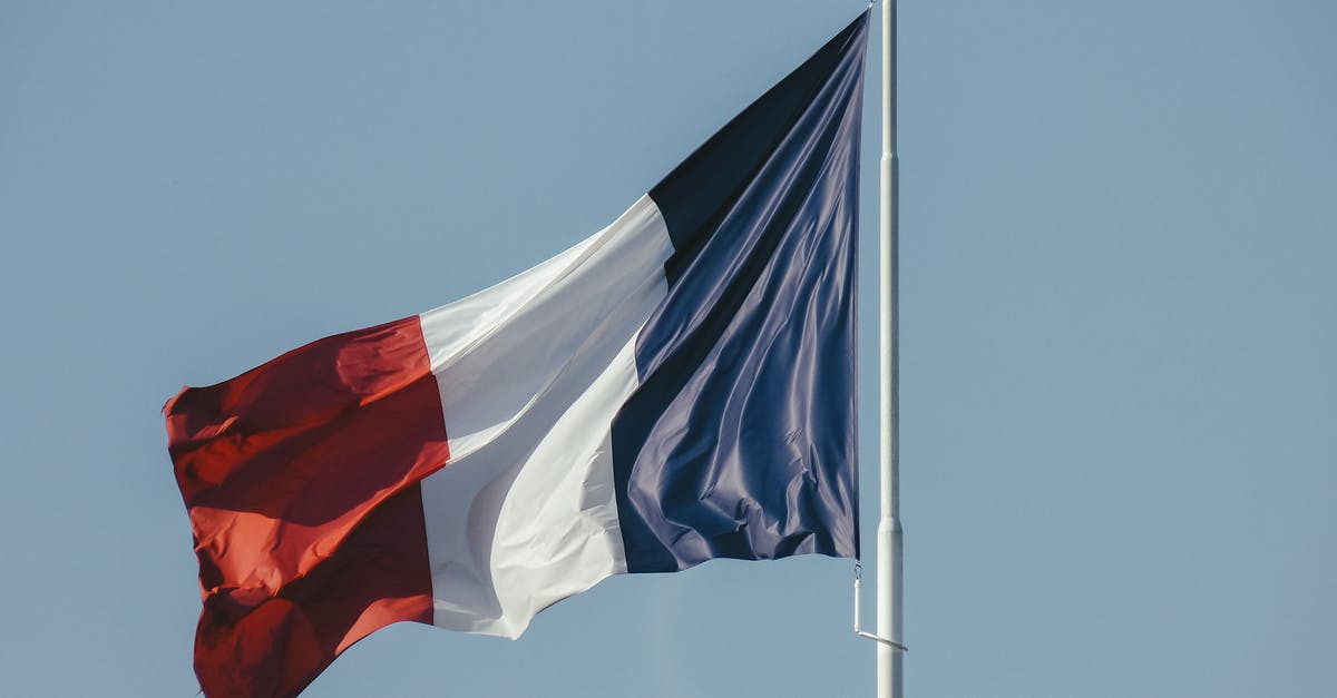 Planning French autoroute drive, aires - French flag against blue sky