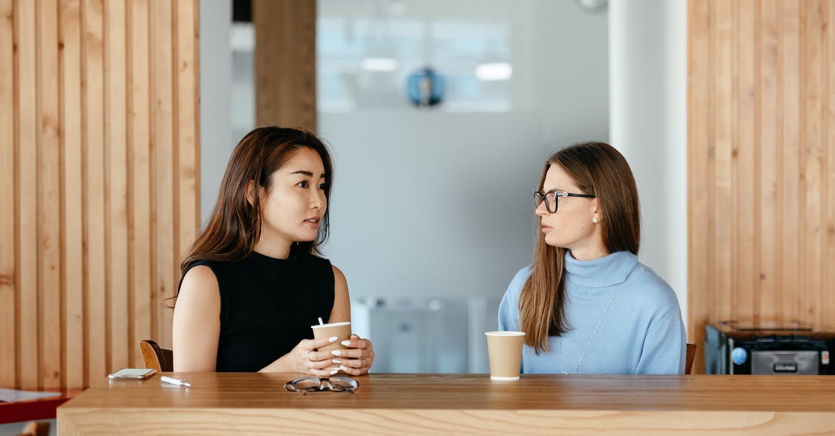 Planning girlfriend visiting me in the UK - Diverse women talking during coffee break at table