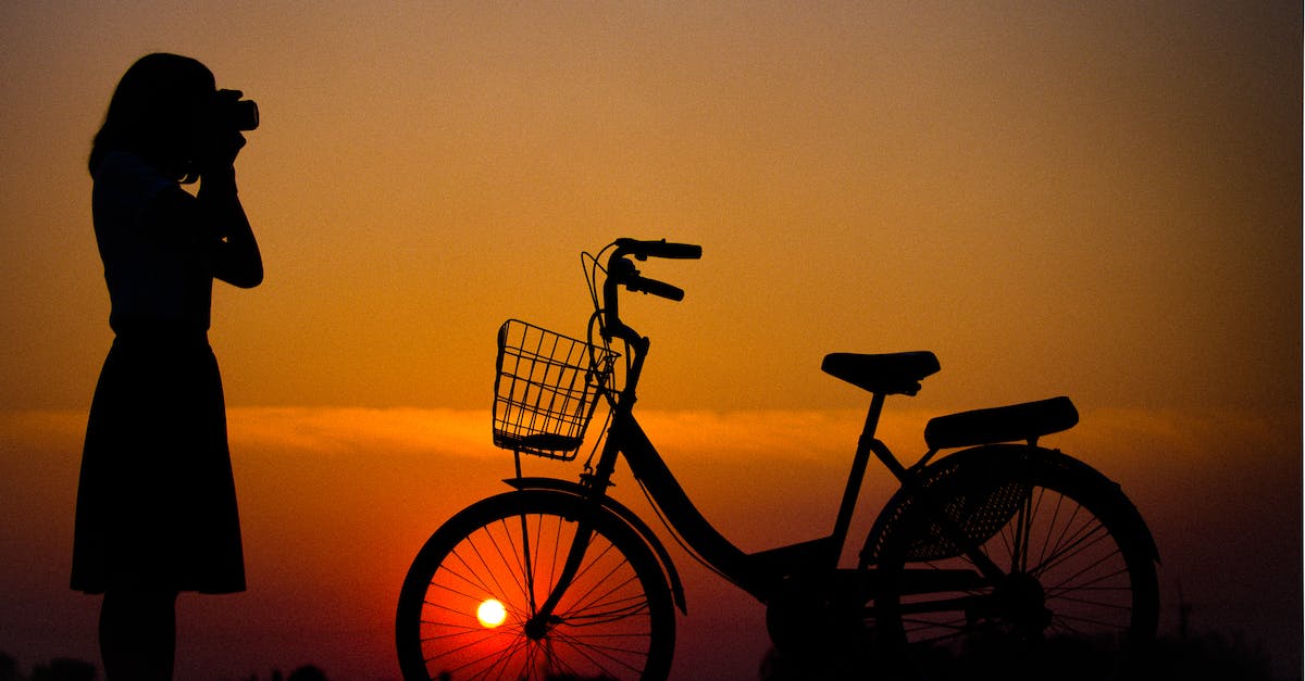 Planning my Singapore tour as a photographer - Silhouette of Woman Using Camera in Front of City Bicycle