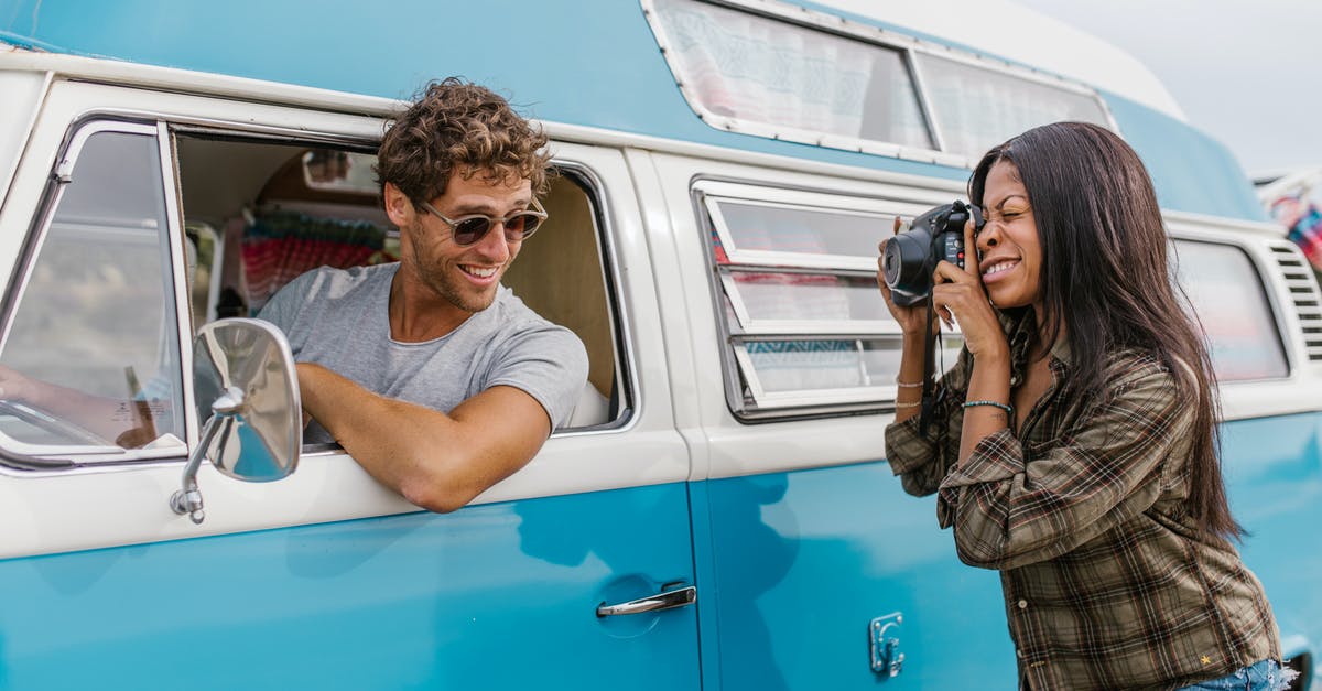 Planning my Singapore tour as a photographer - Woman Taking Photo of a Man Inside the Van