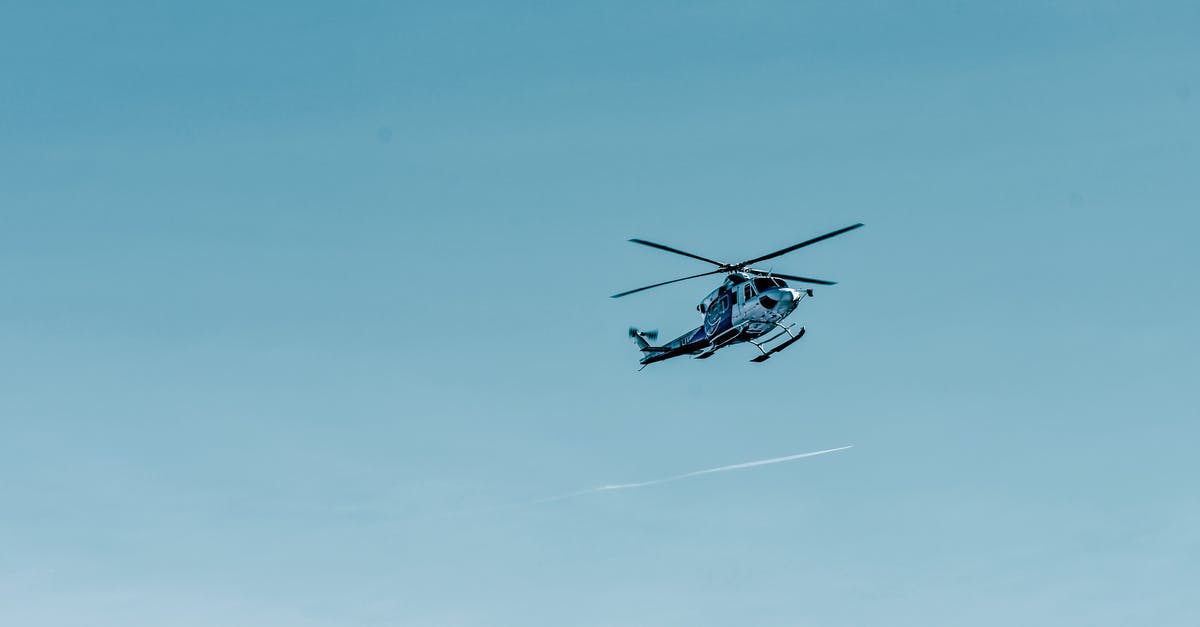 Please let know if flight from Sydney to Kuala Lumpur No. MH140 arrives on KLIA 1 or KLIA 2 - From below of modern helicopter flying in cloudless blue sky on sunny day