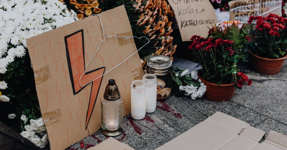 Polish-Born Canadian entering Poland - White Ceramic Jars on White Table