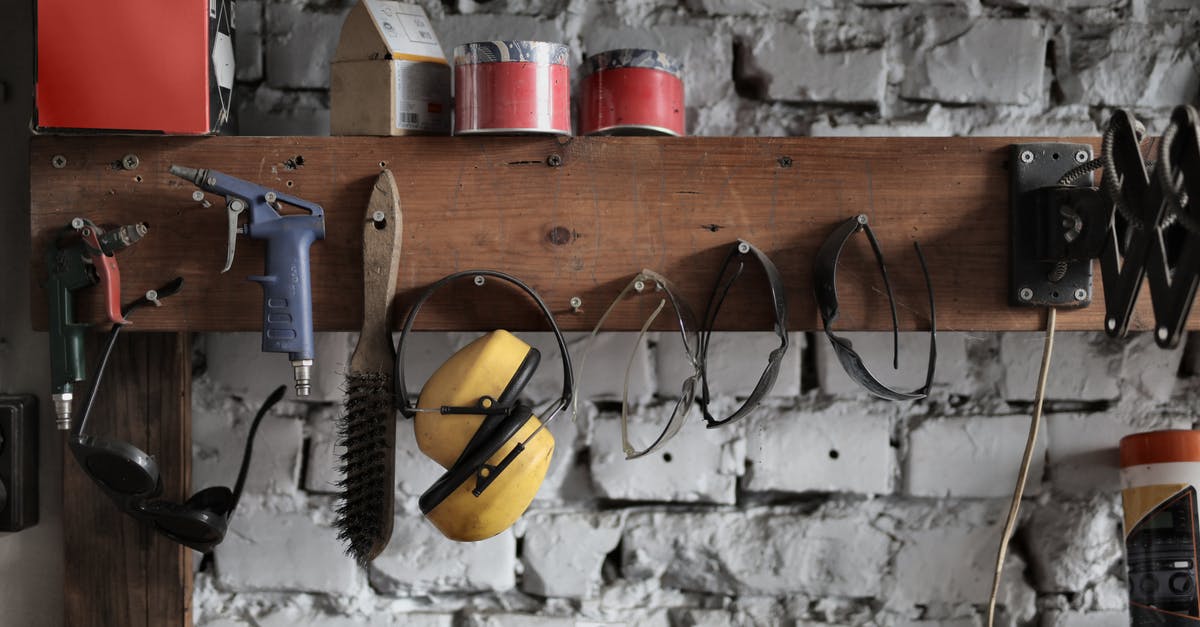 Portable Iron without ironing board - Various instruments hanging on wooden board in garage