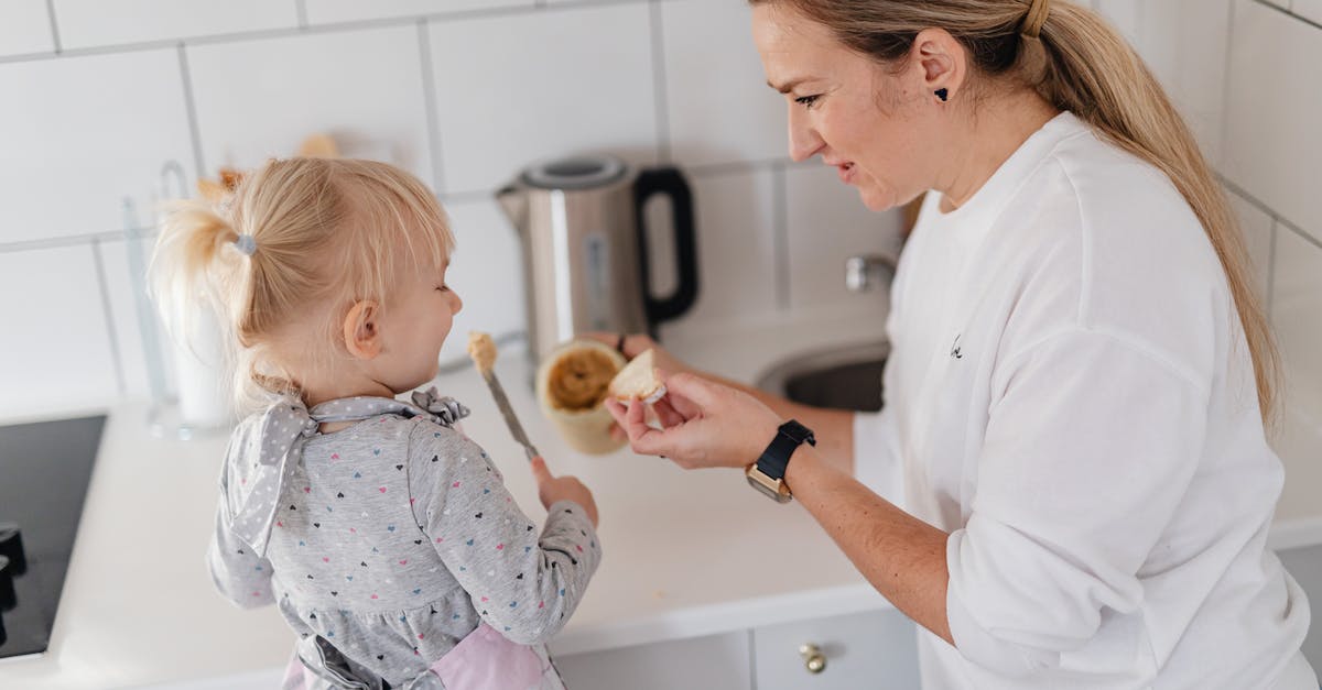 Portuguese cuisine in Lisbon - Man in White Dress Shirt Holding Baby in White and Pink Floral Onesie