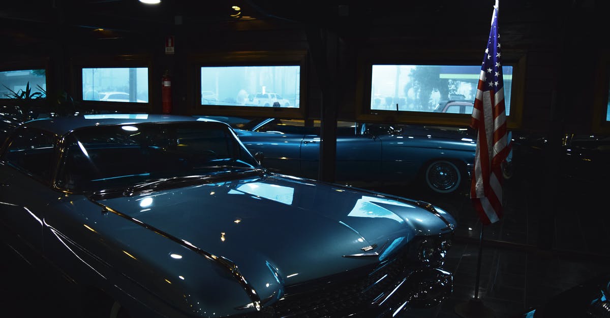 Portuguese gendarmerie cars with continuous blue lights - Classic Gray Chevrolet Car Near Us Flag Inside Garage