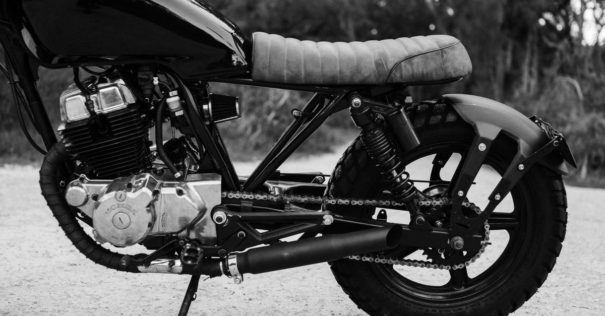 Possibility to cancel part of a trip Lufthansa and DB [closed] - Black and white of modern metal motorcycle parked on road against blurred background