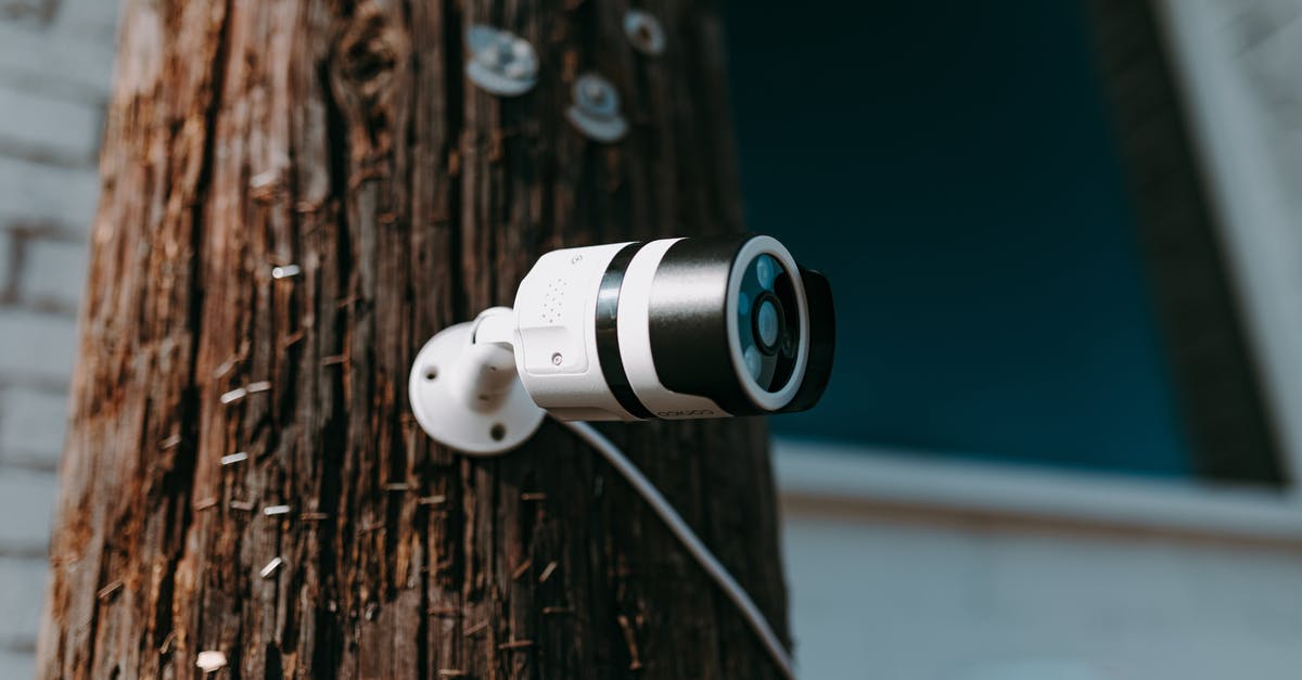 Practical aspects of security when travelling in India - White and Black Camera Lens on Brown Wooden Tree Trunk