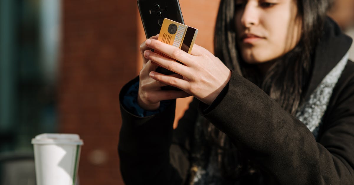 Prague Shopping Times and Method of Payments? - Crop young Hispanic female shopper with debit card making purchase on cellphone near takeaway beverage in cafeteria