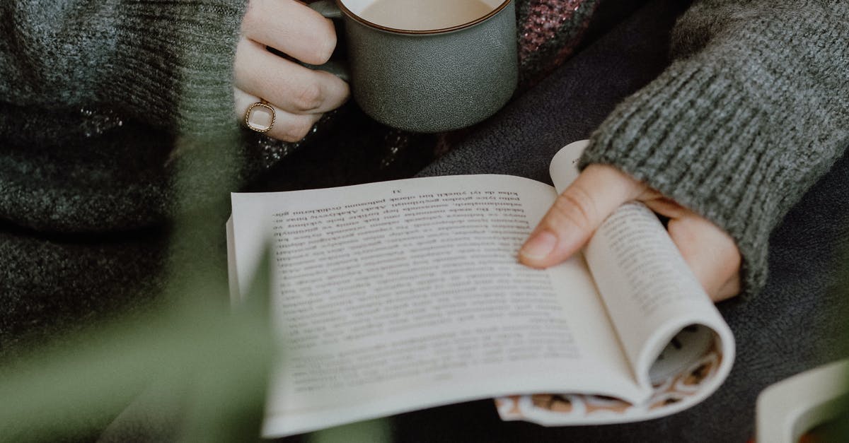 Pre-Booking VS At the stations [closed] - Person in Gray Sweater Holding White Ceramic Mug