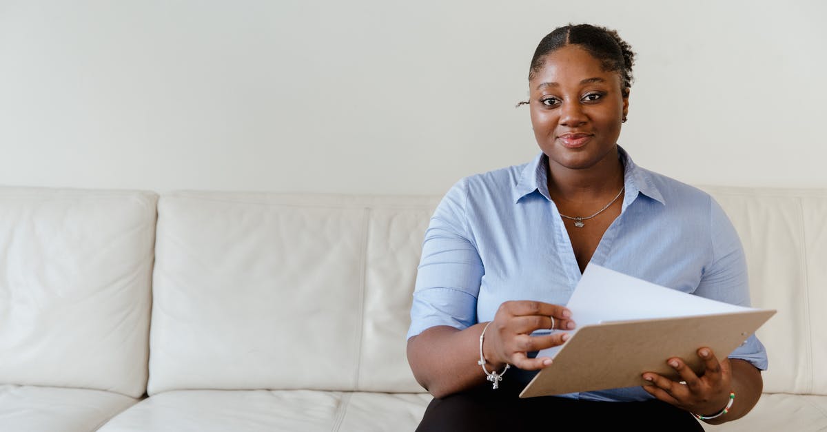 Precheck: one ring to rule them all? - Woman in White Dress Shirt Sitting on White Couch