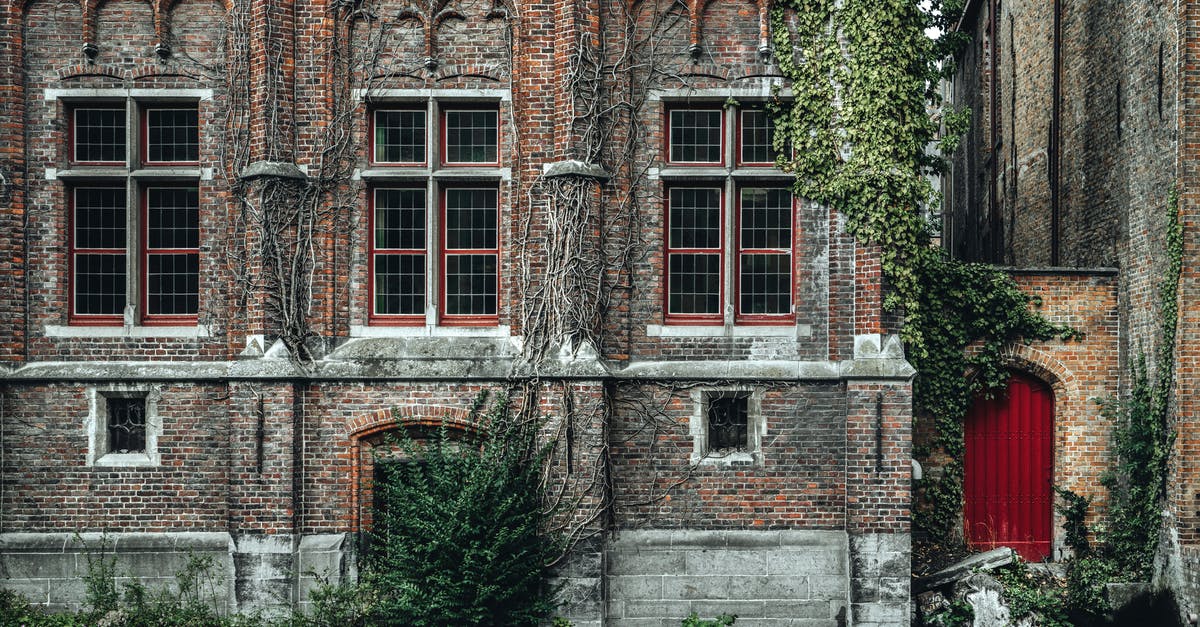 Prepaid data/voice (micro)SIM for travel to Belgium - Fragment of exterior of ancient historic brick building with ornamental walls located on Steenhouwers Canal in Bruges