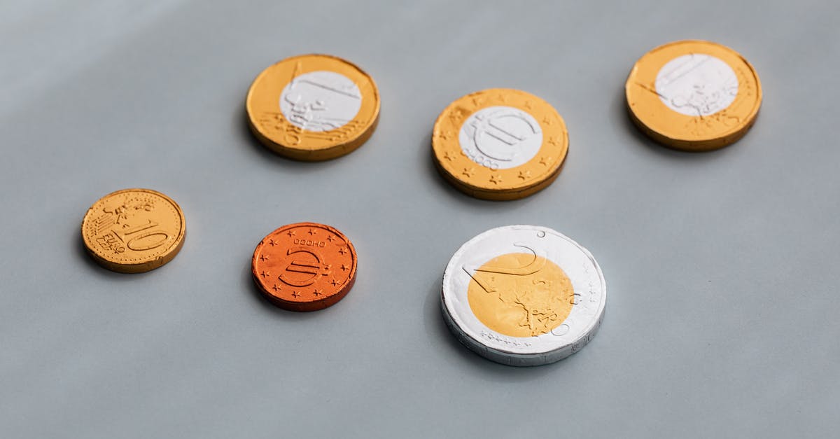 Preparing money for a visit in Dubai [closed] - From above of various coins of European Union in circulation arrangement on gray table