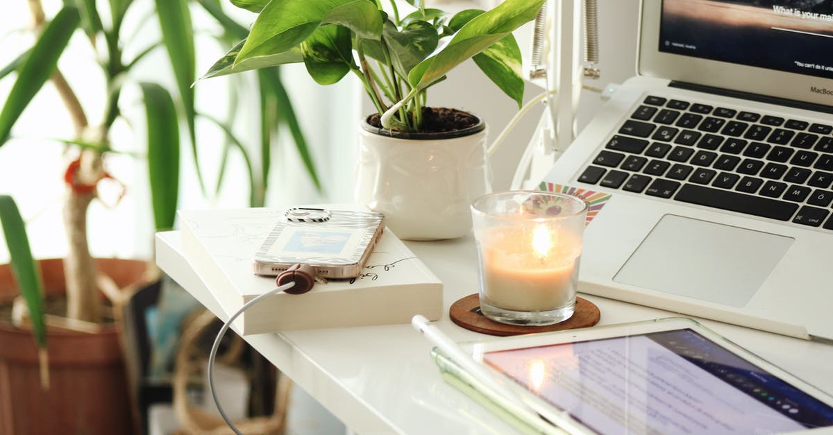 Prepayment not charged yet - Work Space with Candle and Charging Phone on Desk