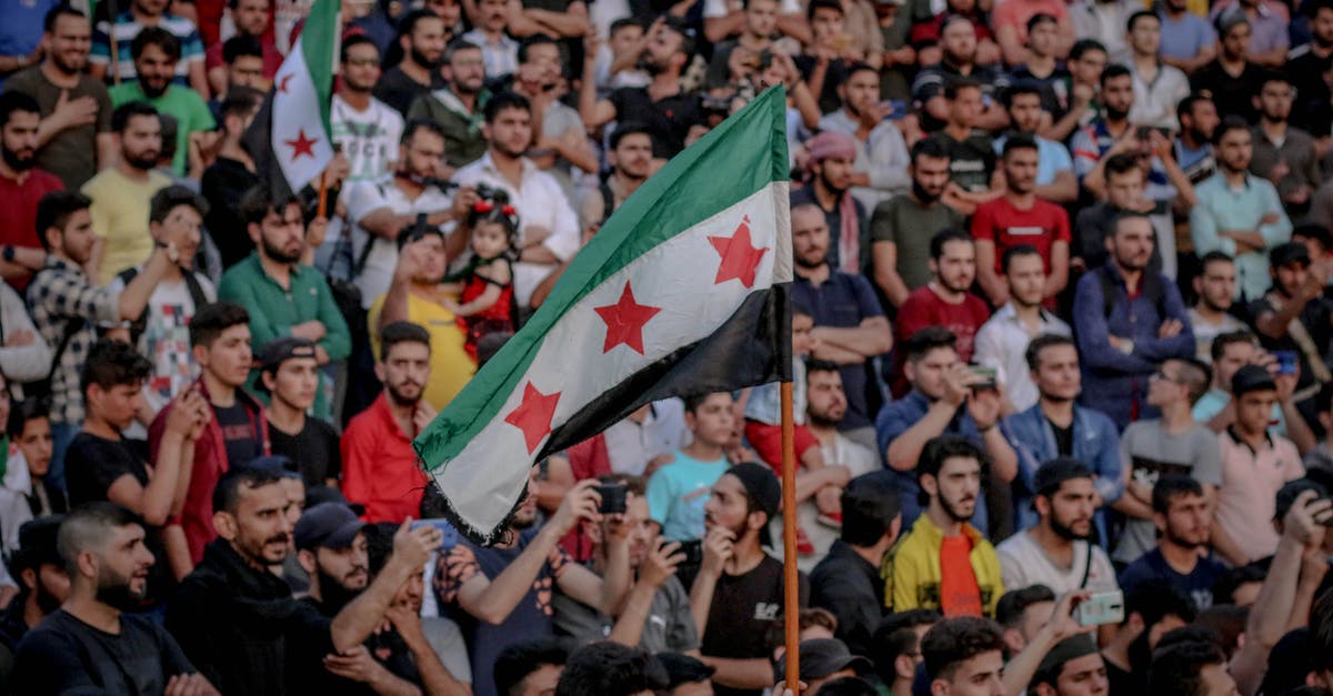 Problem Claiming miles (Star Alliance) operated by SK - Faceless person demonstrating unofficial Syrian flag while standing in crowd