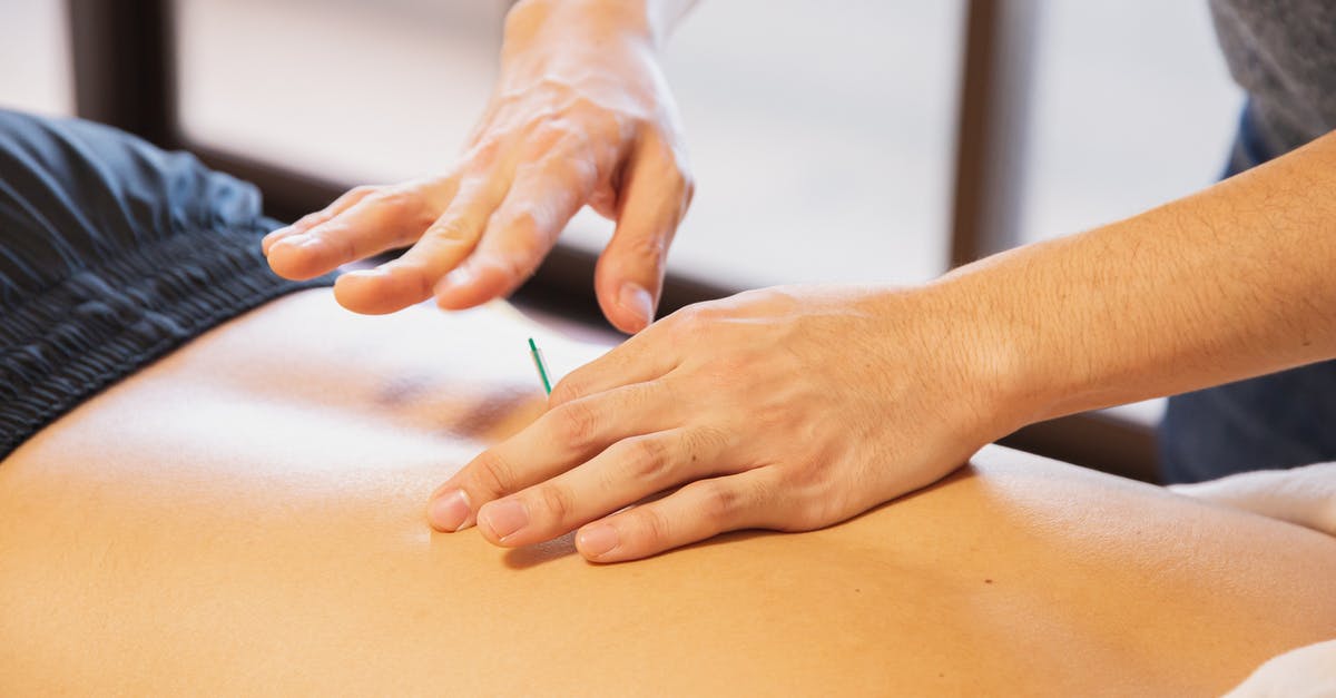 Procedure of uk visa appointment [closed] - Crop anonymous male doctor putting needles on back during acupuncture therapy session in rehabilitation salon