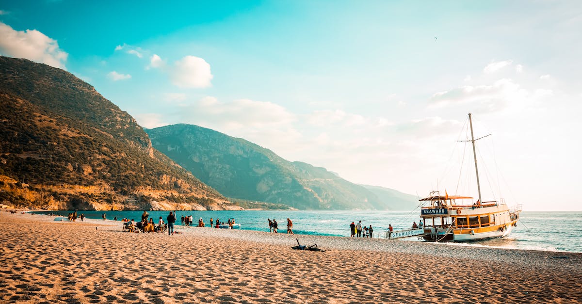 Procedures for boarding a cruise at Miami? - People Sitting on a Beach and Boarding onto a Small Passenger Ship 