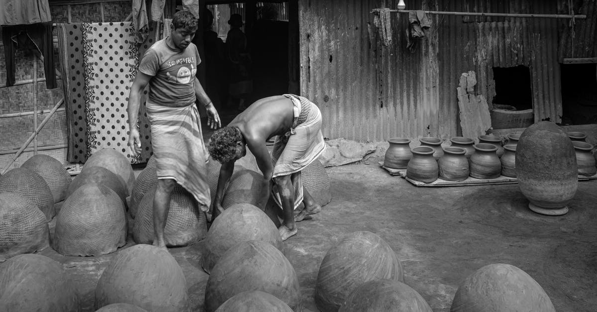 Process and eligibility for transit visa in Dubai - Grayscale Photo of Man and Woman Sitting on Round Wooden Table