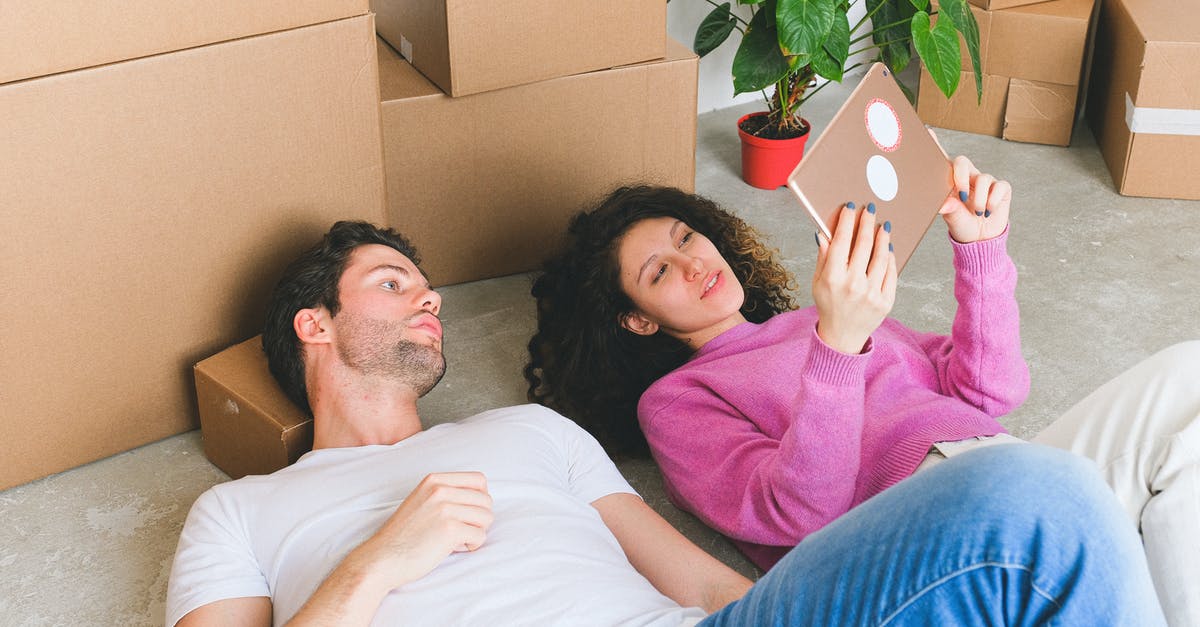 Proof of accommodation when renting a flat unofficially? [closed] - Loving young couple lying on floor and looking at framed photo after relocation