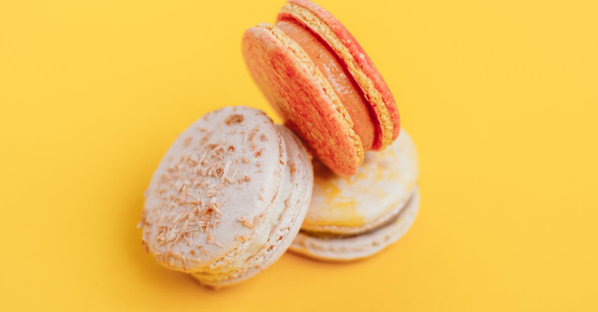 Proof of employment for a Schengen Visa from French Consulate Vancouver? - From above of delicious little homemade macaroons placed on bright yellow background of studio