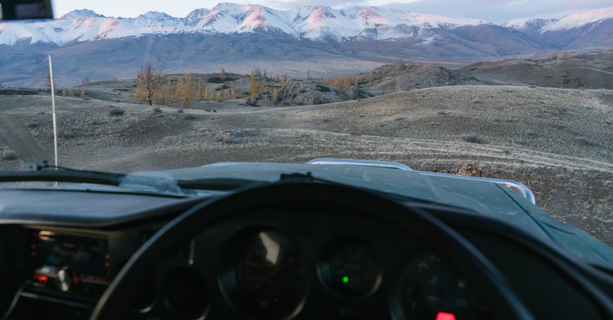 Proof of onward travel in Japan? - Mountains against blue sky seen from inside of car