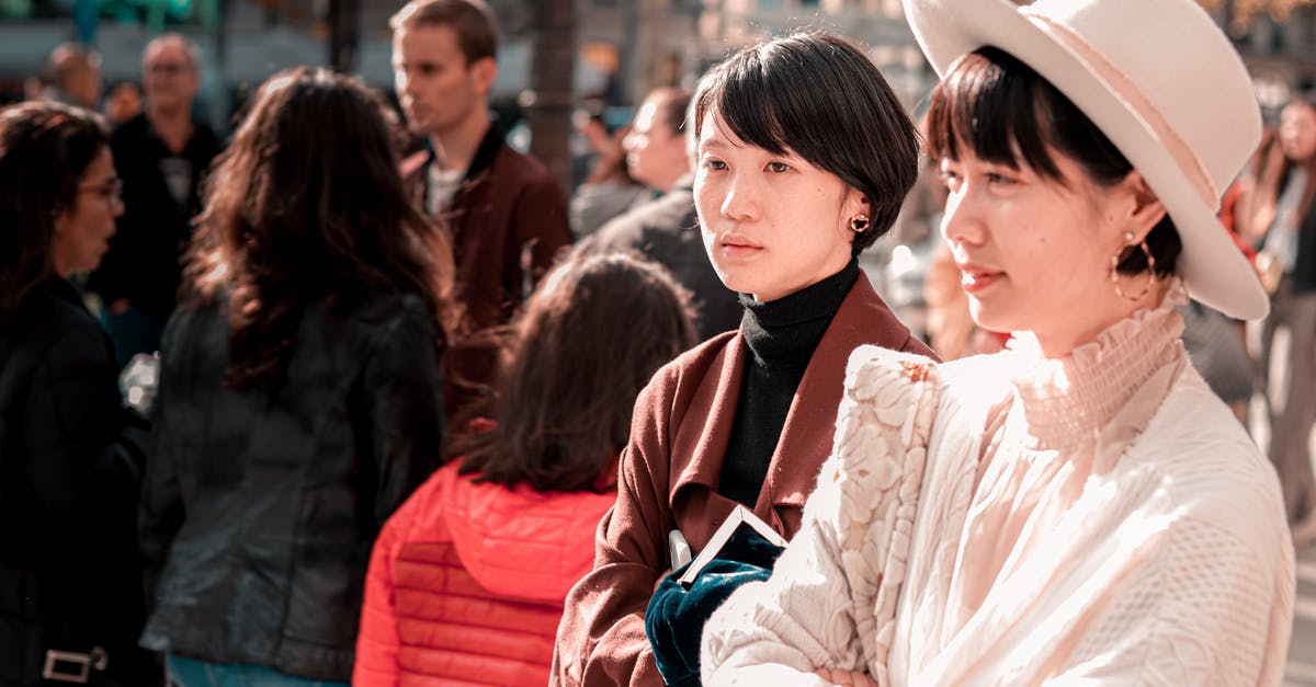 Proof of Relationship when Visiting a Friend in Canada [duplicate] - Stylish ethnic women standing on street on sunny day