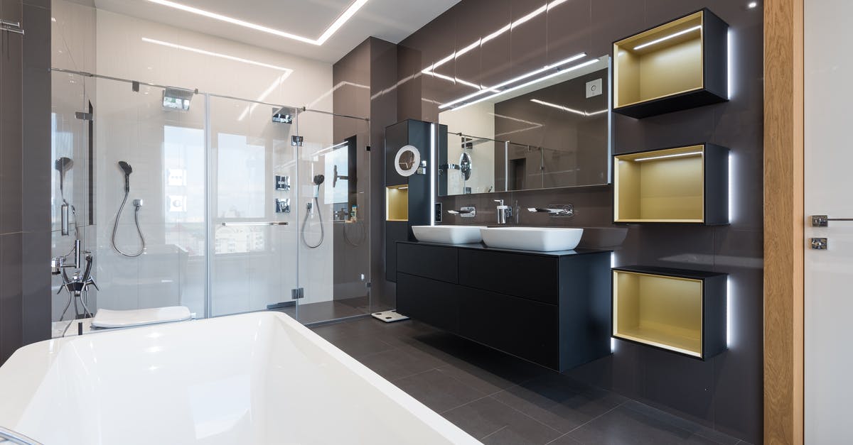 Proper technique to wash laundry in hotel sink? - Interior of contemporary bathroom with glass shower cabin and ceramic bathtub in front of shelves hanging near sinks and mirrors