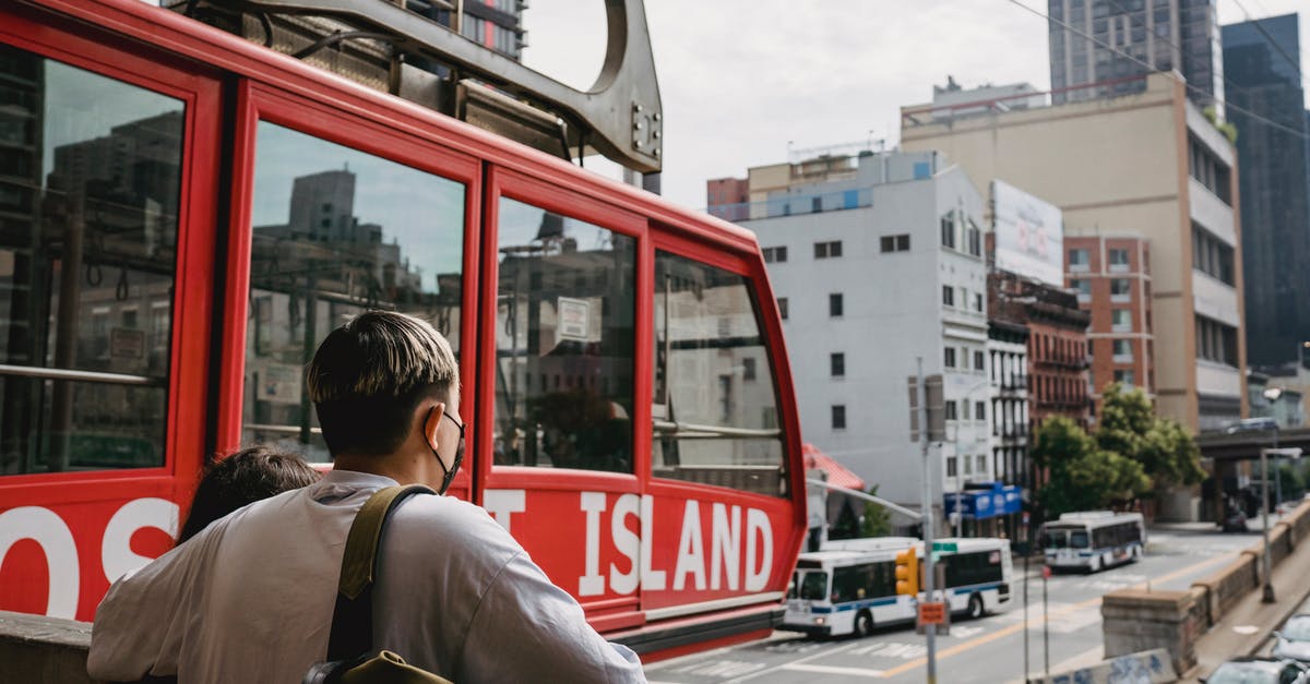 Pros/Cons for horizontal or vertical cabin trollies [closed] - Unrecognizable couple enjoying urban city views near stone railing