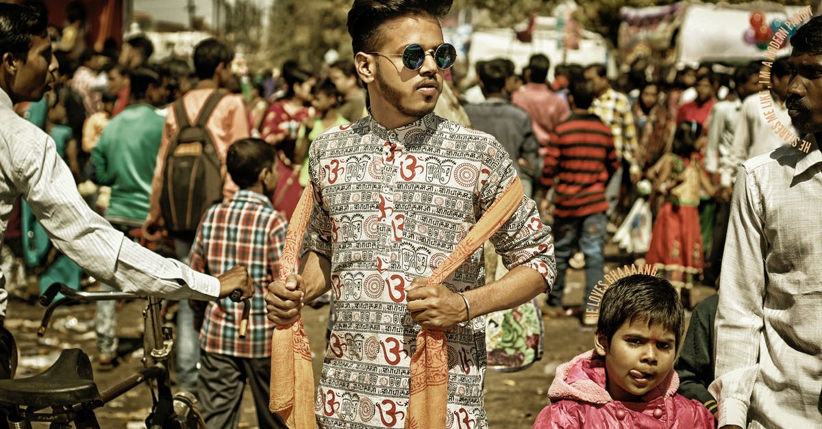 Public strikes in Kerala, India - Man Wearing White and Black Clothes Holding Brown Scarf