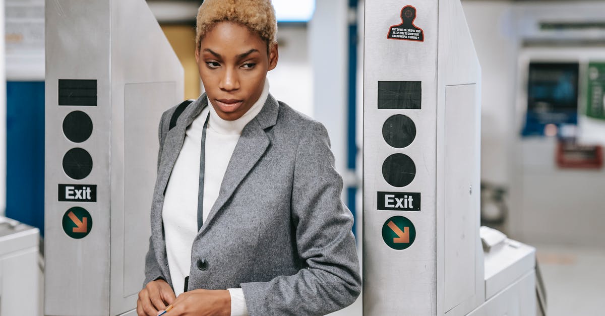 Public transportation ticket in Brussels - Stylish young ethnic woman going through metro entrance gate