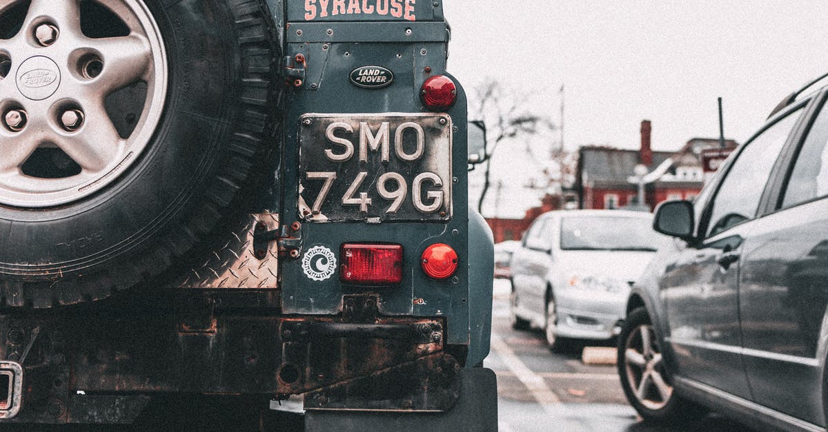 Purpose of stickers copying license plate number? - Black Vehicle Parks Near House Under White Sky