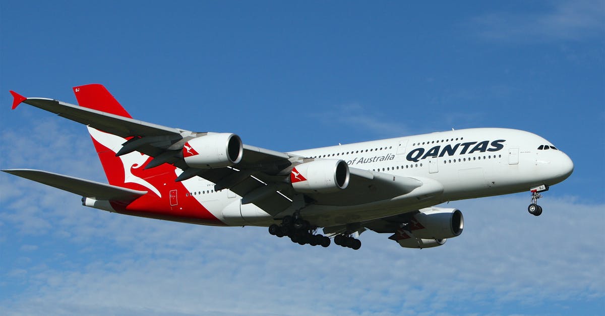 Qantas FF level change ahead of flight - White and Red Qantas Airplane Fly High Under Blue and White Clouds