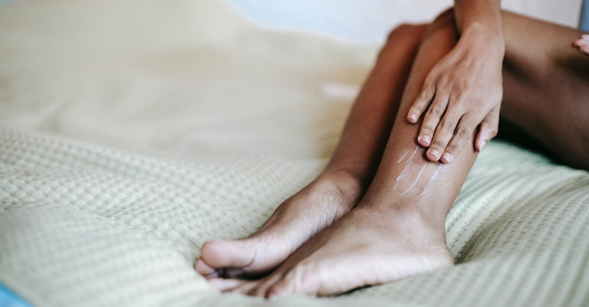 Qantas MEL-SYD-SCL: is the first leg international or domestic - Crop woman moisturizing legs on bed