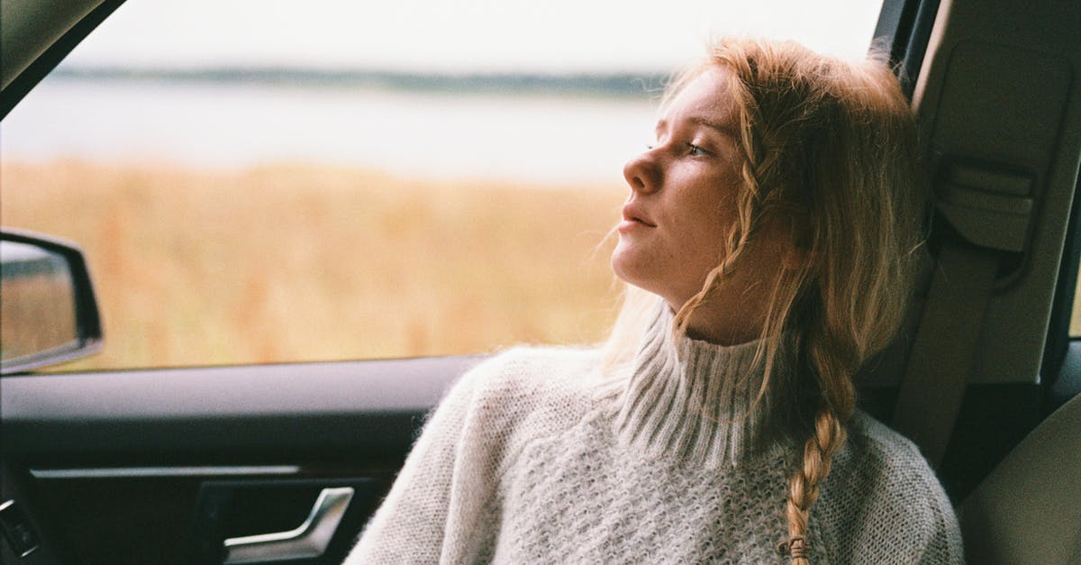 Qatar Airlines: Modifying Seat Selection - Woman in Sweater Sitting Inside a Car