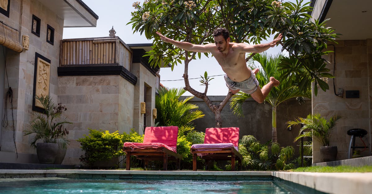 Qatar Airways Free stopover/complimentary hotel - Man Jumping on Pool