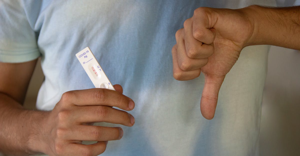 quarantining in the UK pending negative COVID-19 PCR test results - A Person Holding an Antigen Rapid Test Result