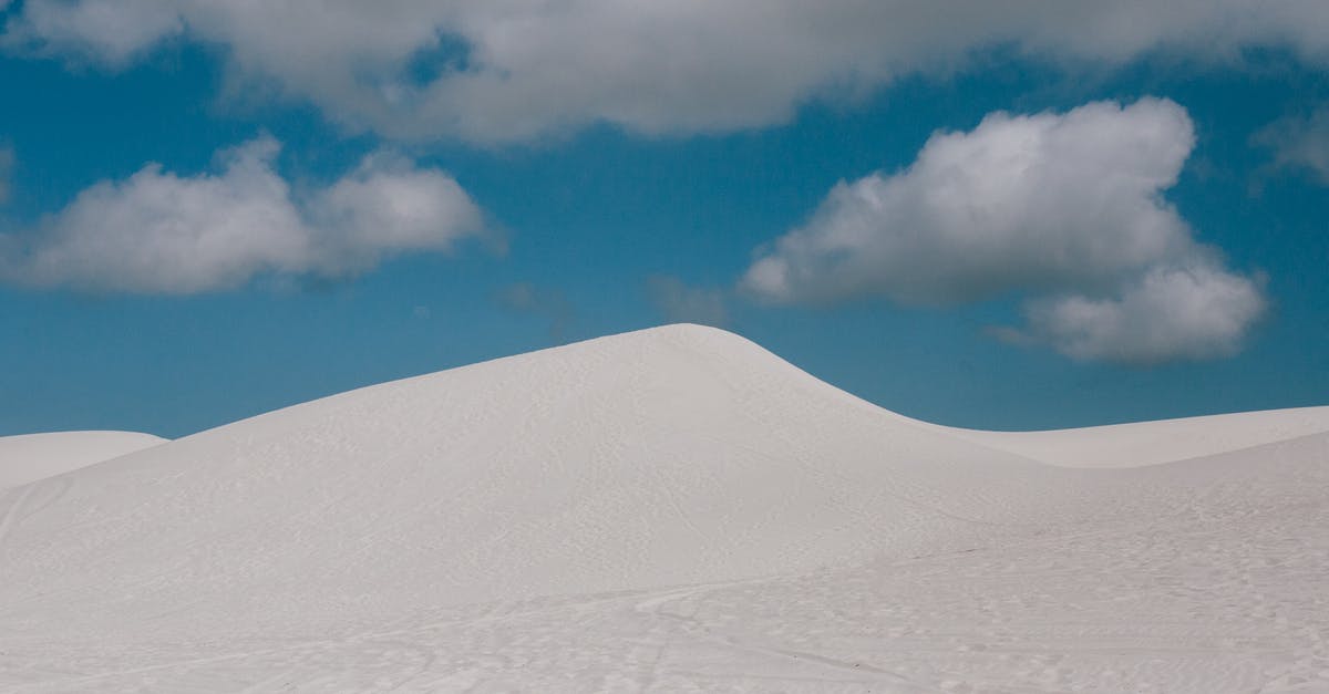 Quer-durchs-Land-Ticket valid from/to Venlo - From below of pure blue sky with clouds over empty endless desert landscape with wheels and shoes tracks on surface