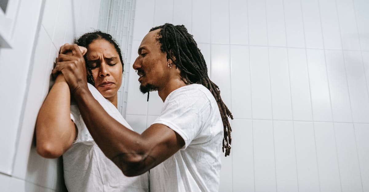 Queries about rejection [closed] - Side view of young black angered man with Afro braids in white t shirt pushing sad wife with closed eyes against tiled wall during conflict in bathroom