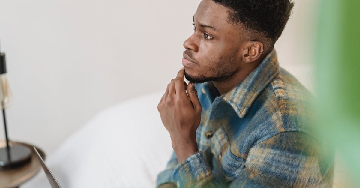 Question about appearance change for passport renewal - Pensive black man thinking in light room