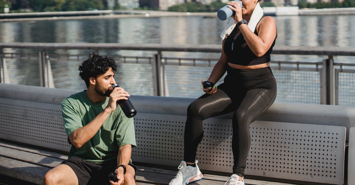 Question about water bottles - 2 Women in Black Tank Top and Black Shorts Sitting on Bench