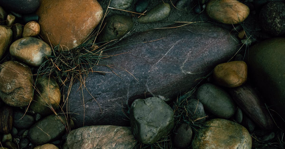 Quiet beach near Istanbul [closed] - From above of rough stones of different colors covered with dry grass on ground of shore