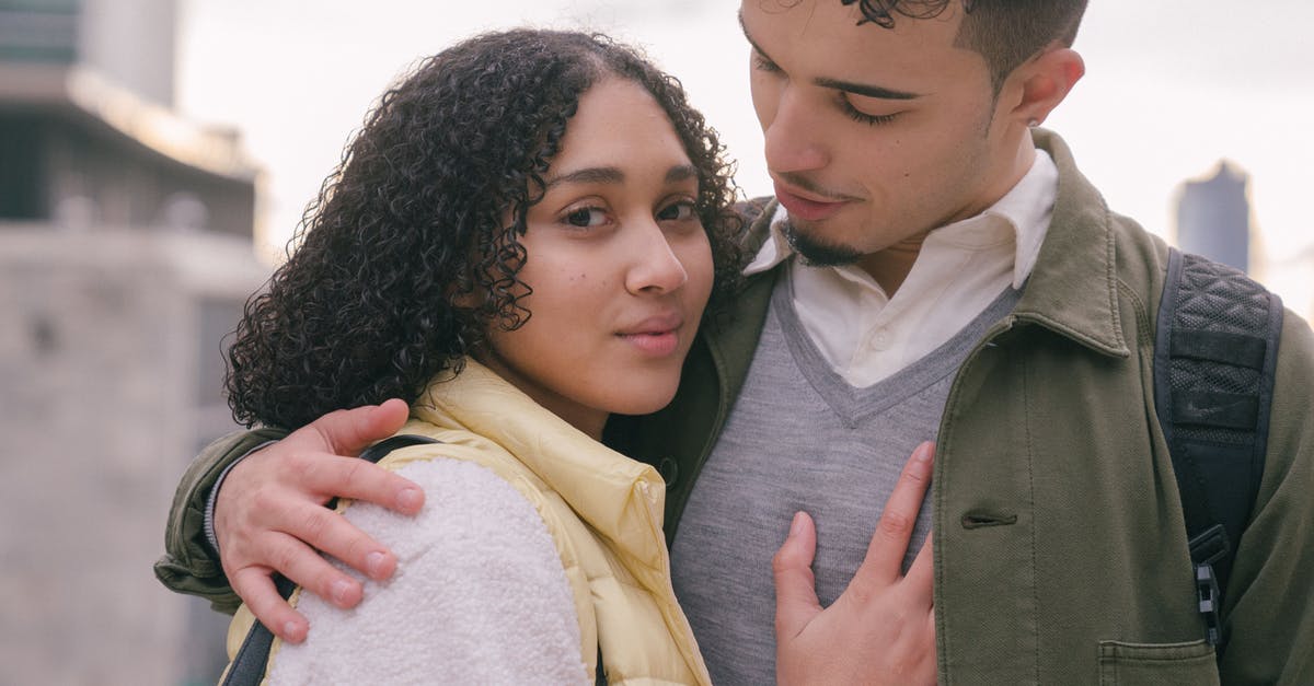 Quiet cities close to Brussels and Amsterdam - Loving tender Hispanic couple embracing on urban street