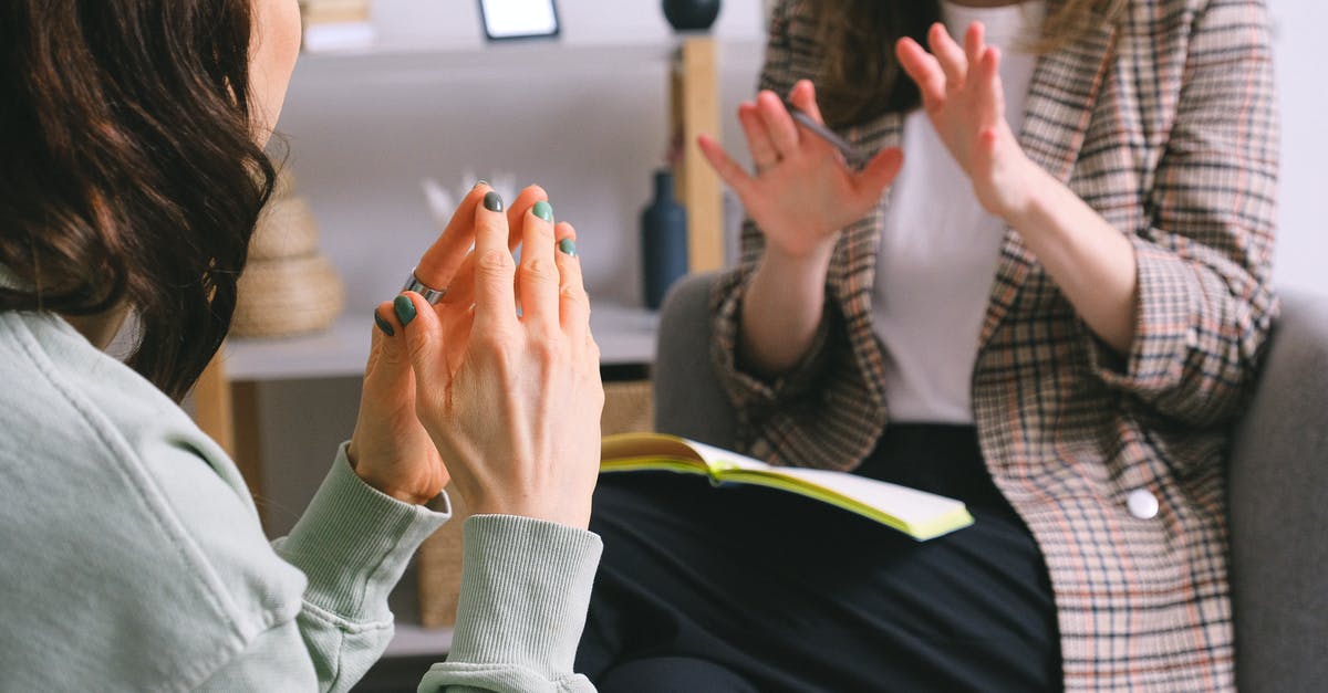 Quitting job to visit my UK boyfriend for longer - Crop unrecognizable female psychologist and patient discussing mental problems during session