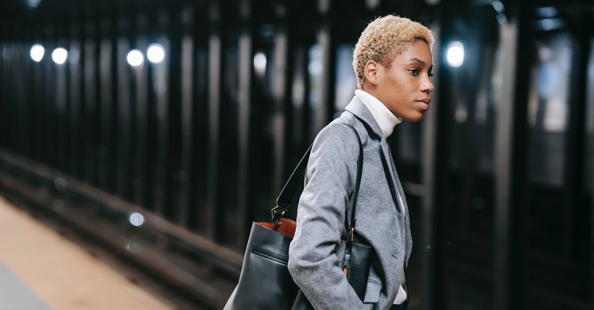 Radio program with public transport focus by country - Calm elegant young black lady standing on platform in underground