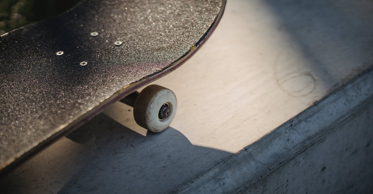 Rail cost from Weeze to Düsseldorf - Shabby black skateboard nose on concrete surface in sunlight