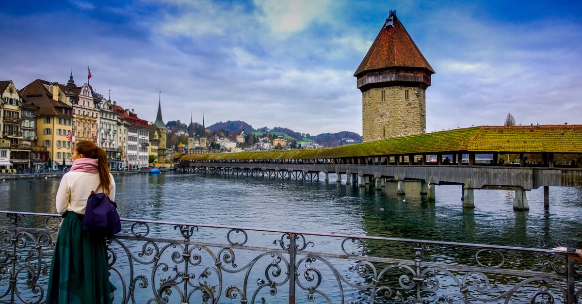 Rail travel in Switzerland Easter Weekend - Woman Standing Against Handrails Beside Body of Water