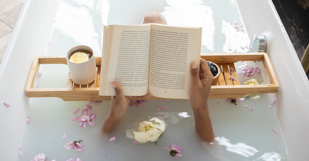 Reaching Spa from Charleroi/other aiport - Woman reading book while resting in bathtub