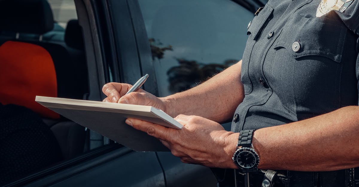 Reason for non-refundable ticket [closed] - Police Officer Writing on a Notebook 